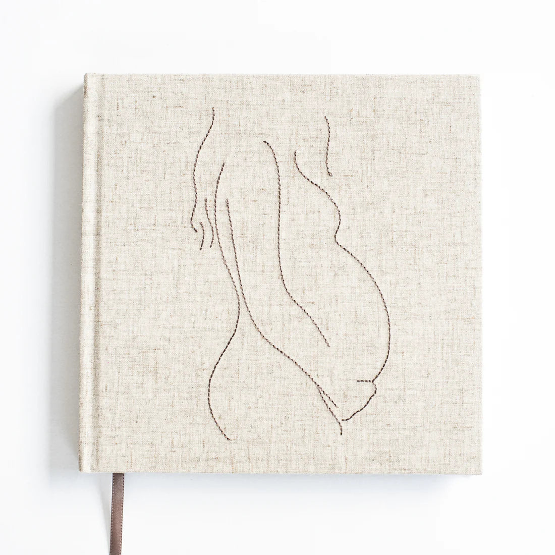 Invulboek Mijn Zwangerschap met lichtbeige linnen cover en gestikte lijntekening van een zwangere buik