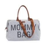 Grijze Mommy Bag verzorgingstas met bruine handvatten en een bruine schouderriem.