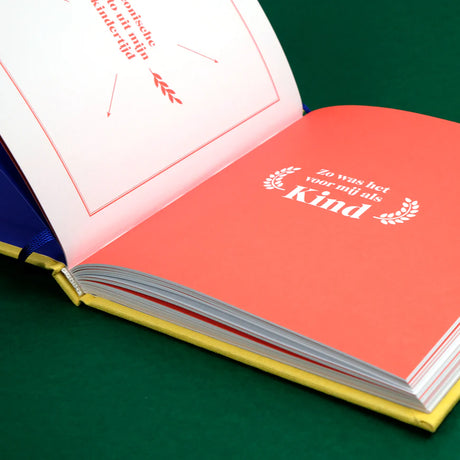 Open Papa Boekje met koraalrode pagina met de tekst ‘Zo was het voor mij als kind’ op een groene ondergrond
