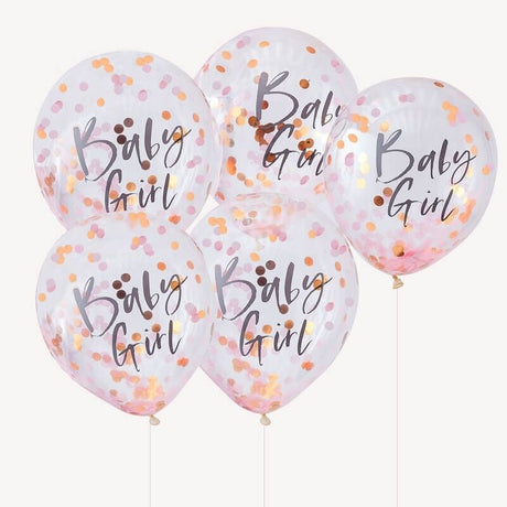 Vijf transparante 'Baby Girl' ballonnen met roze en goudkleurige confetti en lintjes tegen een witte achtergrond.