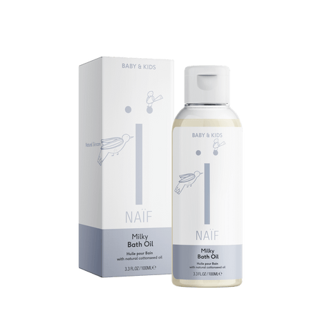 Naïf Milky Badolie voor Baby & Kids in een fles van 100 ml met witte dop, naast de verpakking